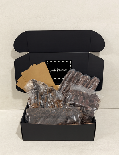 Black gift box with biltong and droewors inside, with a just because sticker 